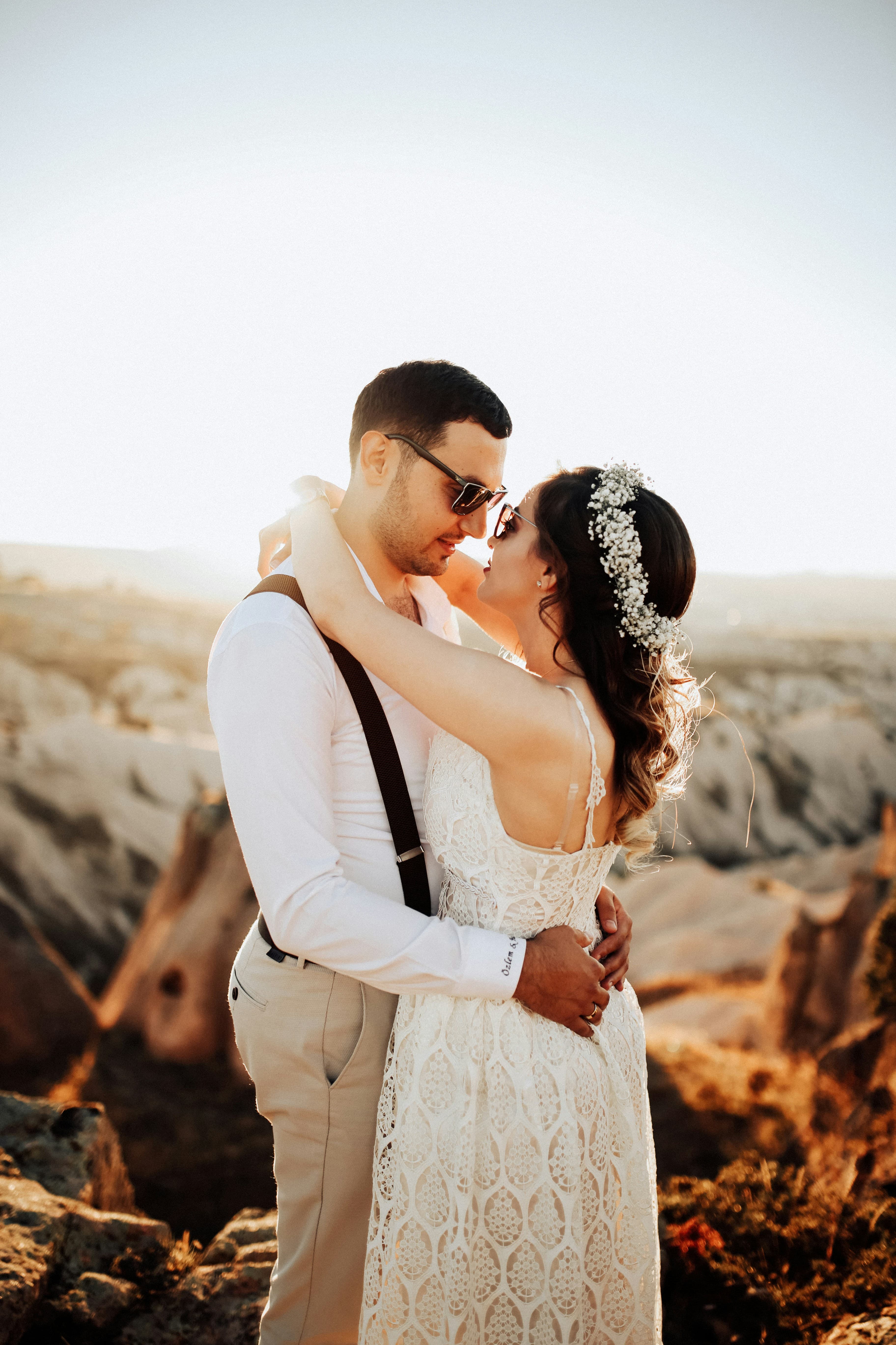 Newlyweds embracing in warm natural light
